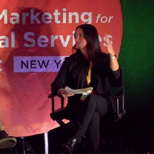 A talk on stage between industry professionals at the Digital Marketing Financial Summit. 